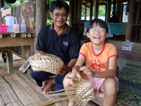 Father Gun coaching Robyn on bamboo weaving